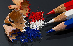 closeup photo of three red, white, and blue color pencils